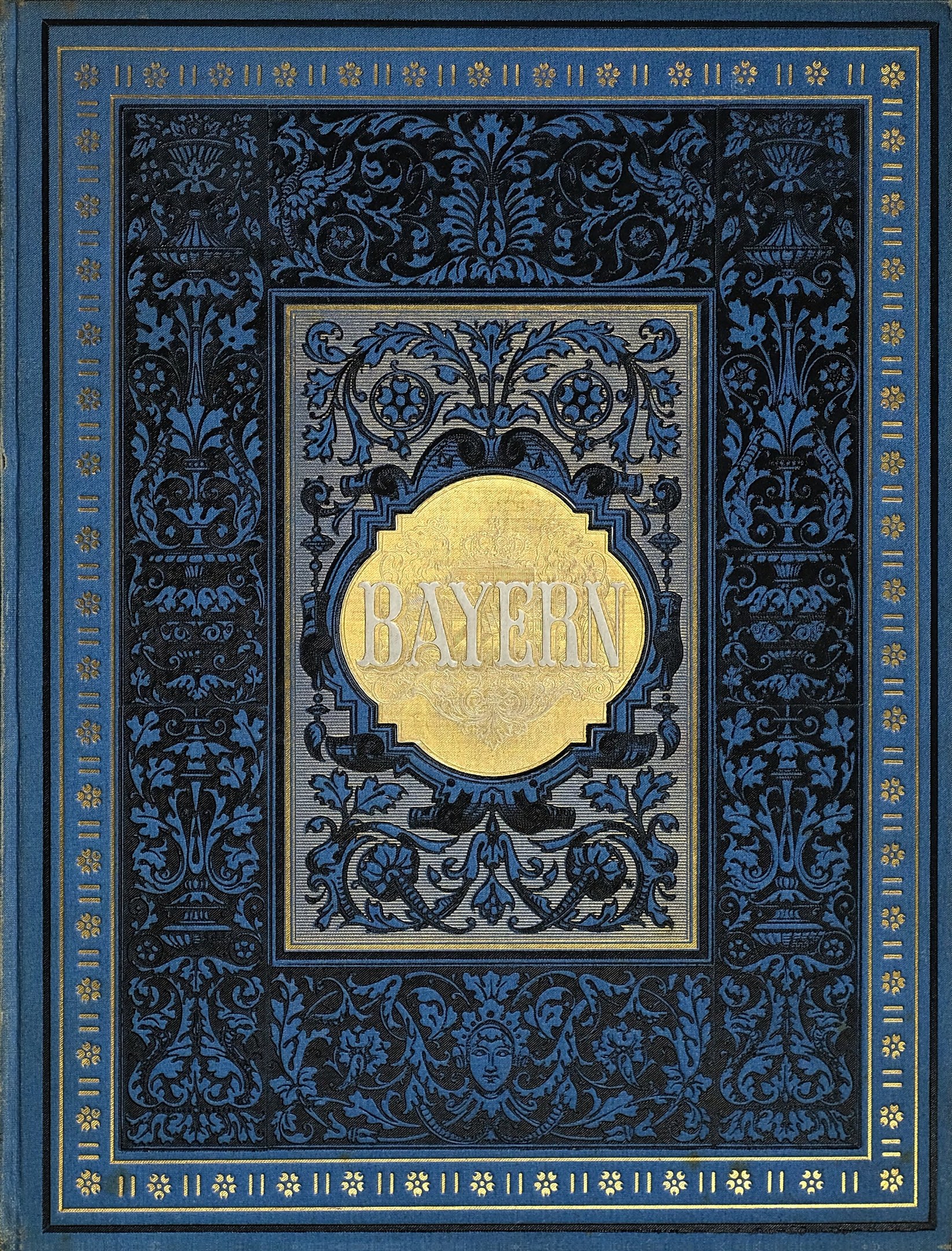 Ein blau-goldenes Buch mit dem Wort 'Bayern' auf dem Cover, das mit detaillierten Dekordesigns verziert ist.