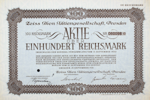 Ein altes deutsches Aktienzertifikat mit schwarzem Rand, auf dem der Text 'Aktie über Einhundert Reichmark' steht, was '100 Reichmarks' bedeutet.