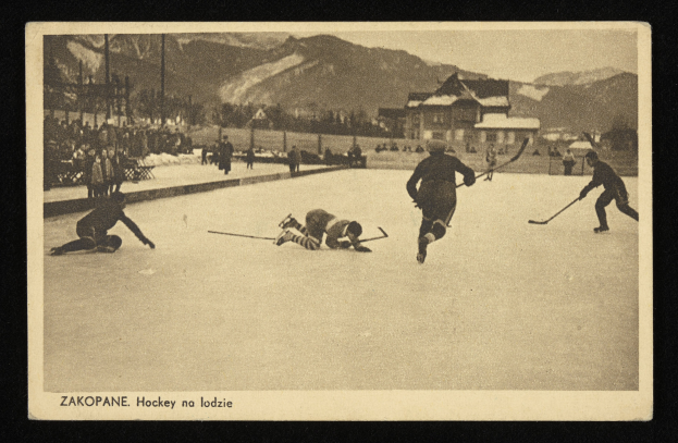 Schwarzes und weißes Foto von Menschen, die Hockey auf einem Eissportstadion spielen, mit Gebäuden, Bäumen, Pfählen und Bergen im Hintergrund und Text am unteren Rand.